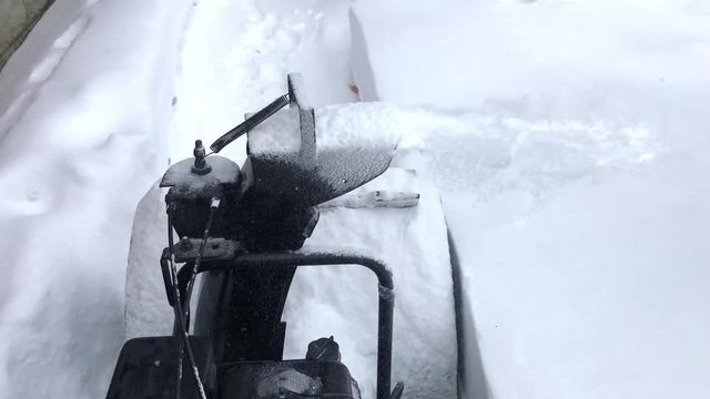 Snow Blower, snow blowing from operators point of view POV 4k unstabilized handeheld realistic, shaky, vibrating