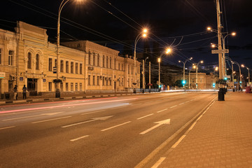 Plakat Street, roadway of the night city, cars drive and people walk.
