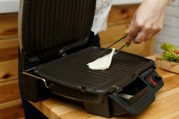 Frying cheese in grill