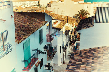 Beautiful narrow street in the old town with white houses and tiled roofs. Altea, Spain