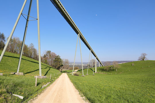 View of the conveyor belt transporting stones from Gabenchopf quarry to the cement plant. Village of Villigen, Switzerland.