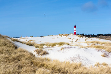 Red and white lighthouse on the hill