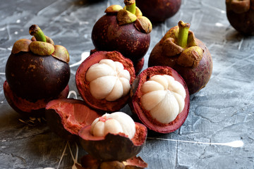 Fresh mangosteen fruits isolated on neutral background.