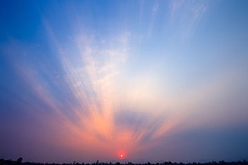 Fototapeta premium Natural Sunset Sunrise Over Field Or Meadow. Bright Dramatic Sky And Dark Ground. Countryside Landscape Under Scenic Colorful Sky