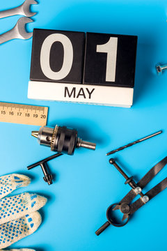 May 1st. Day 1 of may month, calendar on blue background with tools. Labor day