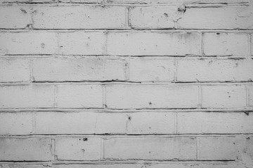 Old grungy brick wall. Free space for an inscription. Can be used as a background or poster. Fragment of a wall with bumps and peeling paint.