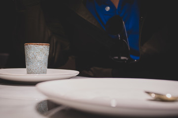 Rustic Espresso shot cup on a wooden table on a dark background - with copy space. 