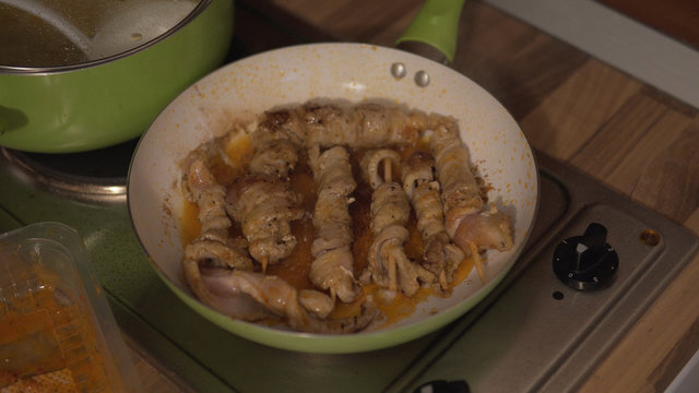 Cook a skewers of meat in pan