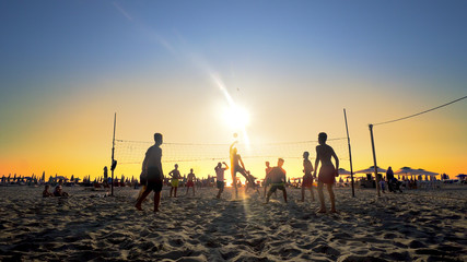 Durres, Albania - circa August, 2017: Group of friends playing volleyball at the beach