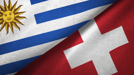 Uruguay and Switzerland two flags textile cloth, fabric texture