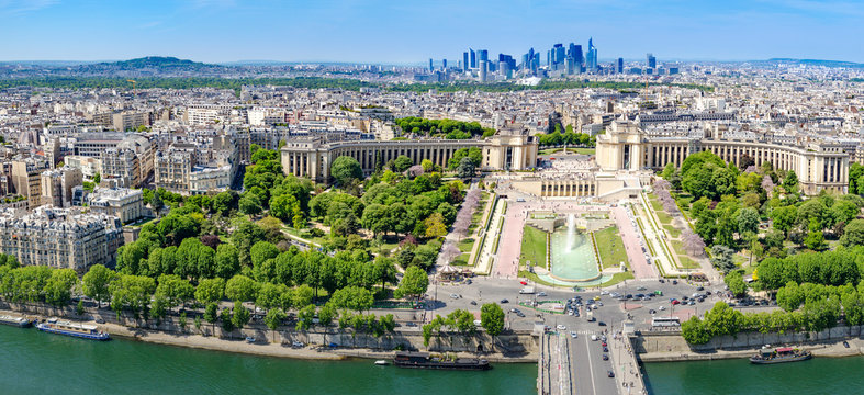 Aerial panoramic view of Paris, Trocadero with Chaillot Palace fountains and gardens and La defense contemporary business center skyscrapers at background horizon