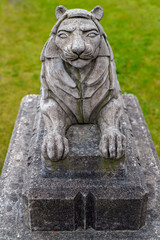 Fototapeta premium Small stone lion statue in the Stanley Park close to the Lions Gate Bridge