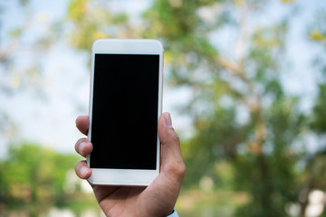 Hand holding Mobile Smart Phone and using Smart phone