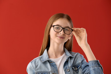 Portrait of cute teenage girl on color background