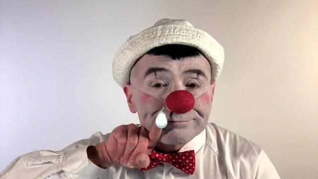 Emoji Clown - Sneezing Face. A mime clown sneezes and has a drop of mucus on his nose, then falls slowly. (Closeup shot size)