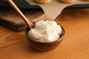 Bowl of coconut oil on wooden table