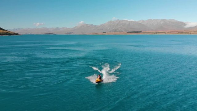 SLOWMO - Jet Ski on Beautiful Turquoise Blue Water - Lake Tekapo, New Zealand - Aerial