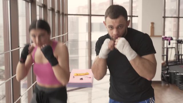 Training session of a fitness women and the trainer practice together.
Kick boxing training , workout concept