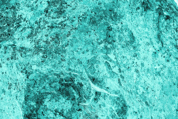 Fototapeta na wymiar Vintage azure background. Rough painted wall of turquoise color. Imperfect plane of cyan colored. Uneven old decorative toned backdrop of aqzure tint. Texture of teal hue. Ornamental stony surface.