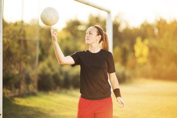 Female soccer player spin a ball on the finger