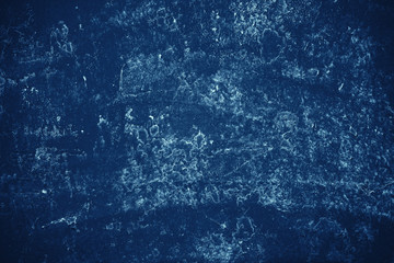 Vintage blue background. Rough painted wall of sapphire color. Imperfect plane of blue colored. Uneven old decorative toned backdrop of cyan tint. Texture of sapphirine hue. Ornamental stony surface.