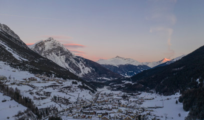 winter landscape (at sunset) of the high Valtellina, between the Italian central Alps, village of valdidentro, sondrio, italy