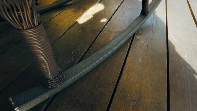 Rocking chair detail rocking on wooden floor