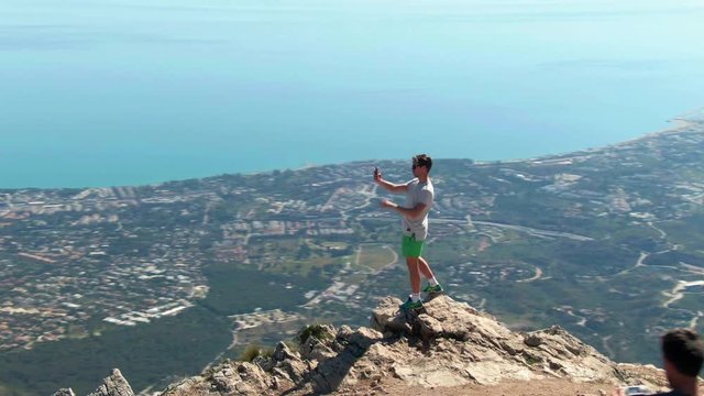 Male tourist from Sweden taking selfies on top of La Concha in Spain.
