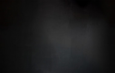 Black texture for designer.Product showcase  background with Concrete wall and plaster.Artistically textured.Rough illuminated surface