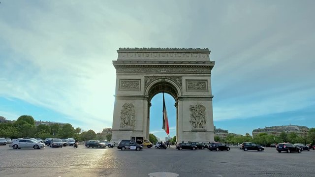 Car traffic on Champs-elysees in front of Arc de triumph in Paris, France, cinematic steadicam movement