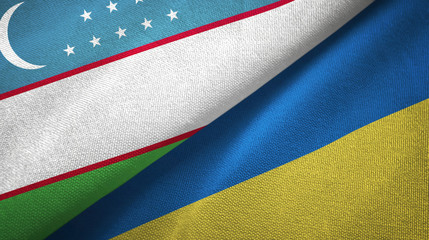 Uzbekistan and Ukraine two flags textile cloth, fabric texture