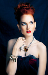 beauty stylish redhead woman with hairstyle and manicure wearing jewelry pearl close up