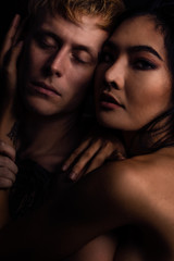 sexual nude portrait of caucasian male and Asian female couple