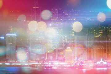 Fototapeta premium Abstract colorful circular bokeh with city background. Double exposure