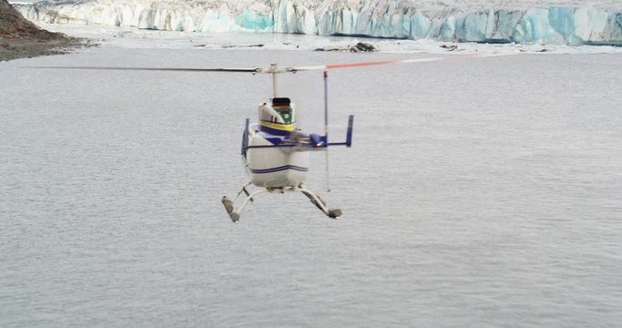 Aerial, helicopter flies over icy waters in Alaska