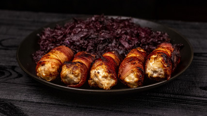 Fried homemade grilled sausages or chevapchichi with stewed sauerkraut on a wooden rustic background