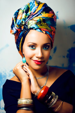 beauty bright african woman with creative make up, shawl on head like cubian closeup smiling