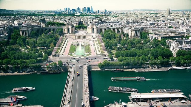 Aerial view of street scene with vehicle and boat traffic  in Paris next to the Eiffel Tower with view of Trocadero and La Defence