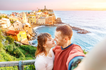 Fototapeta na wymiar Vernazza, national park Cinque Terre, Liguria, Italy, Europe. Tourists happy couple taking selfie photo on camera