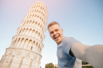 Travel tourists Man making selfie in front of leaning tower Pisa, Italy