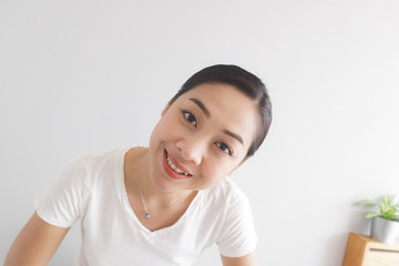 Smile and happy woman in white t-shirt. Concept of happy and thinking positive.