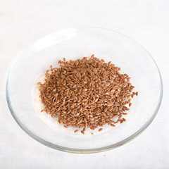 flex seeds in a bowl isolated on white