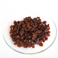 Raisins -dried- in bowl isolated on white background