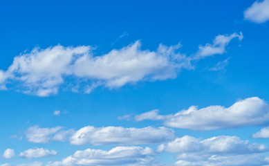 Beautiful blue spring sky with white clouds. Background.