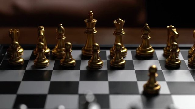 Close up Man moving chess pawn defeat enemy on chessboard winner and victory concept,strategy planning business Slowmotion