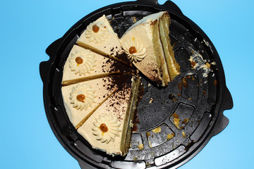 Biscuit cake with chocolate and caramel. Blue background. Top view