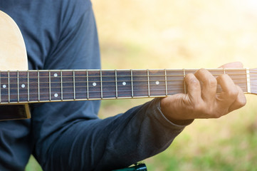 Hand holding guitar chords
