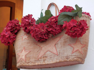 Woven basket with artificial geraniums