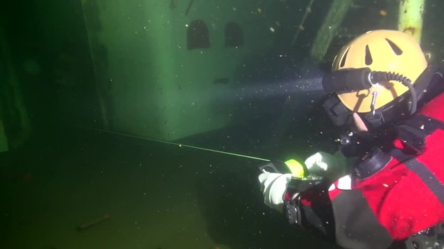 Diver reels in the line on the way out of the wreck