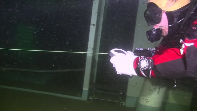 Diver reels in the line on the way out of the wreck